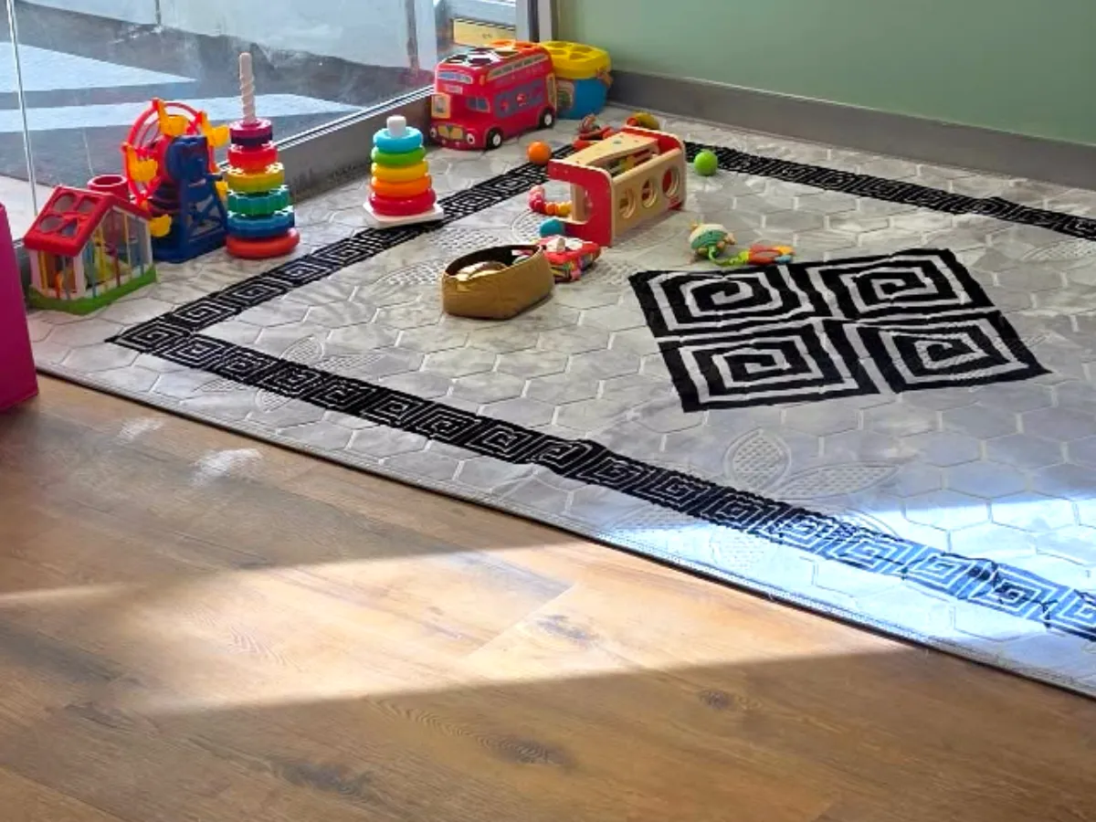Sunny corner with a soft rug, stacking rings and baby toys