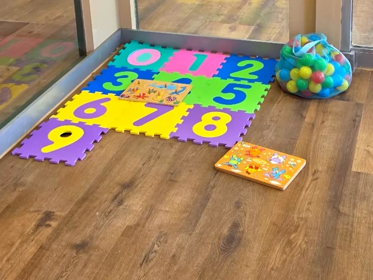 Foam number mat, wooden puzzles and a bag of play balls